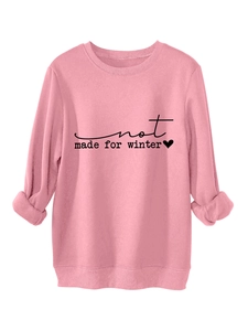 Detailed view of Not Made For Winter print and small heart on pink crewneck sweatshirt