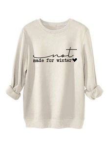 Detail of beige fleece sweatshirt with not made for winter print and folded cuffs