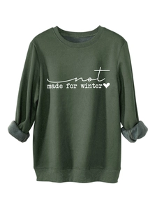 Detail of dark green sweatshirt showing soft fleece lining and Not Made For Winter print
