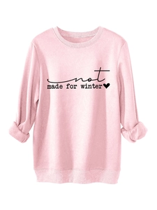 Detail of pink fleece sweatshirt featuring not made for winter text and heart print