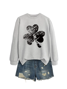 Close-up of a grey crewneck sweatshirt featuring a vintage black clover graphic design