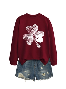 Close-up of burgundy crewneck sweatshirt with white clover print and ripped denim shorts