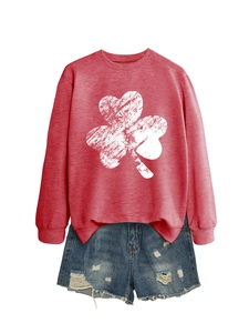 Detail of red shamrock crewneck sweatshirt paired with distressed denim shorts