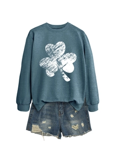 Blue-grey sweatshirt with clover print and distressed denim shorts flat lay display
