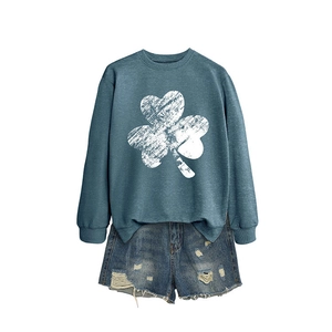 Women's blue shamrock print sweatshirt paired with distressed denim shorts casual set
