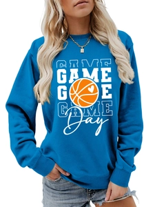 Detail of blue crewneck sweatshirt featuring white GAME lettering and orange basketball design