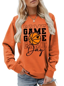 Detailed macro view of Game Day basketball print on orange cotton blend sweatshirt