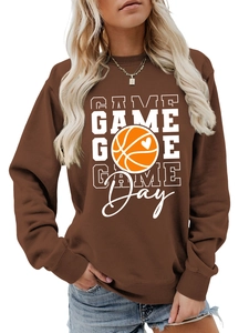 Macro detail of ribbed cuff and Game Day basketball heart print on brown sweatshirt