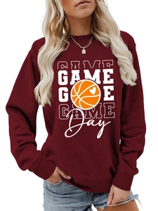 Macro detail of wine red sweatshirt featuring game day basketball and heart graphic print