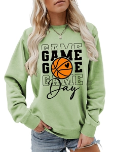 Detail of sage green sweatshirt featuring ribbed crew neck and basketball heart print