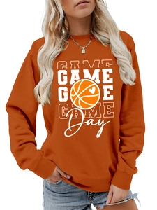 Detail of orange game day sweatshirt showing ribbed cuffs and basketball graphic