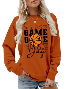 Detail of orange crewneck sweatshirt with Game Day basketball heart print and ribbed cuffs