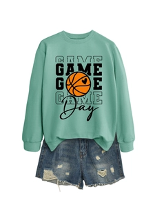Detail of mint green sweatshirt with basketball heart print and ripped denim shorts