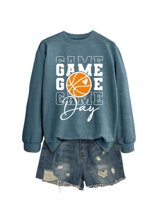 Detail of blue Game Day basketball sweatshirt paired with distressed denim shorts