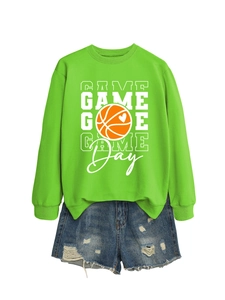 Flat lay of bright green Game Day basketball sweatshirt paired with ripped denim shorts