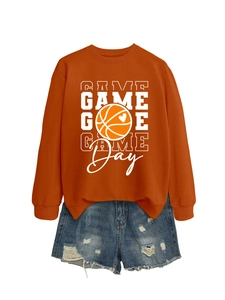 Flat lay detail of rust orange Game Day basketball sweatshirt and distressed denim shorts