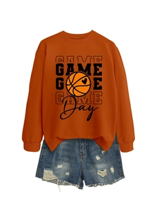 Detail of orange Game Day sweatshirt with basketball heart print and ripped denim shorts
