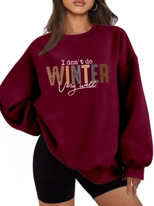 Close-up of I Don't Do Winter slogan print on a thick burgundy fleece sweatshirt