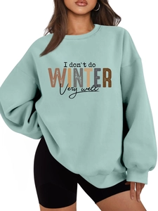 Detail of mint green sweatshirt with I don't do WINTER very well print and ribbed cuffs