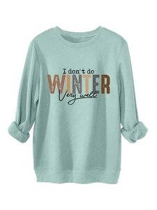 Detail of light blue sweatshirt with 'I don't do WINTER' text and ribbed knit cuffs