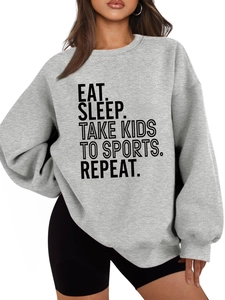 Detail of Eat Sleep Take Kids To Sports slogan printed on grey oversized sweatshirt