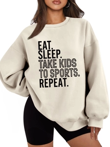 Detail of Eat Sleep Take Kids slogan print on loose cream crewneck fleece sweatshirt