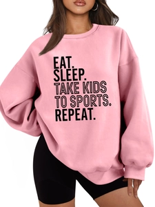 Detail of Eat Sleep Take Kids slogan print on pink oversized crewneck sweatshirt
