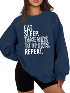 Navy blue oversized sweatshirt detail featuring bold Eat Sleep Take Kids white slogan