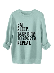 Detail of mint green sweatshirt featuring Eat Sleep Take Kids To Sports slogan print