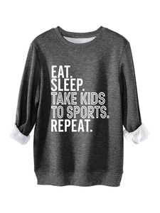 Detail of dark grey sweatshirt showing warm white fleece lining and slogan print