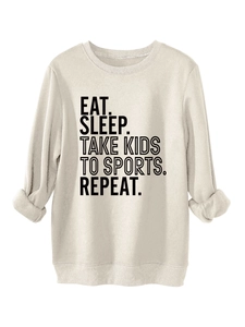 Detail of Eat Sleep Take Kids slogan print on beige oversized crewneck sweatshirt