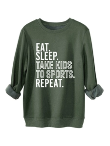 Detail of dark green sweatshirt showing soft grey fleece lining and white printed slogan