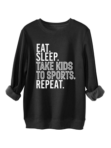 Detail of fleece lining and slogan print on a casual black crewneck sweatshirt