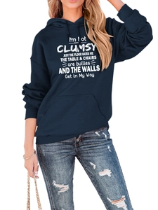 Detail of navy blue hoodie with white typography and distressed ripped denim jeans