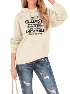 Detail of cream hoodie featuring kangaroo pocket and funny slogan with blue jeans