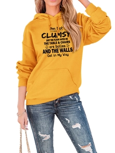 Detail of ginger yellow hoodie with black text slogan and front kangaroo pocket