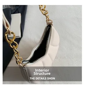 Detail view of large capacity cream shoulder bag showing internal structure and gold chain