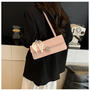 Pink suede shoulder bag featuring a sparkling rhinestone buckle and silk scarf detail