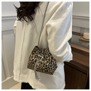 Detail of leopard print bucket bag with silver chain strap and drawstring closure