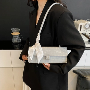 Chic silver rectangular baguette bag with heart-patterned silk scarf on shoulder strap