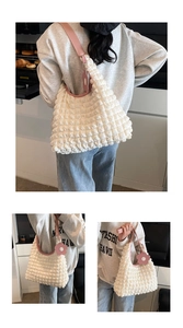 Detailed macro view of white bubble texture tote bag with pink flower charm and leather strap
