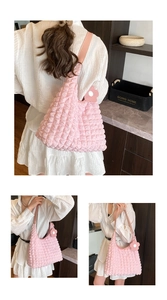 Detail of pink waffle texture tote bag with floral charm and soft leather strap