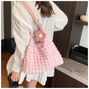 Close-up of pink bubble texture tote bag with a matching large floral charm pendant