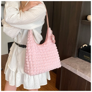 Detailed shot of pink bubble texture tote bag with flower pendant and pleated surface