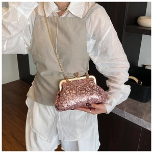 Detail of rose gold sequin evening clutch bag with golden heart clasp and chain strap