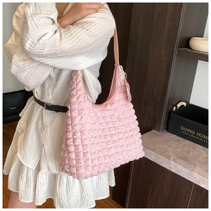 Detailed view of pink bubble texture fabric and soft pleated design on a hobo shoulder bag