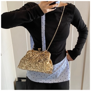 Sparkling gold sequin evening clutch bag with metal frame and chain strap detail