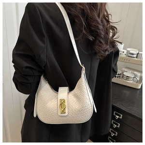 Detail of white woven texture shoulder bag with elegant golden oval metal lock buckle