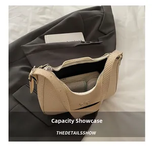 Internal view of beige woven crescent bag with bow showing daily essentials capacity
