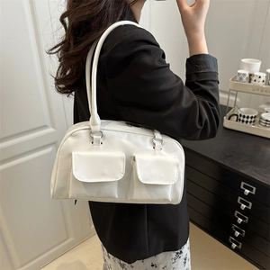 White glossy Boston shoulder bag with dual front pockets and premium metal hardware